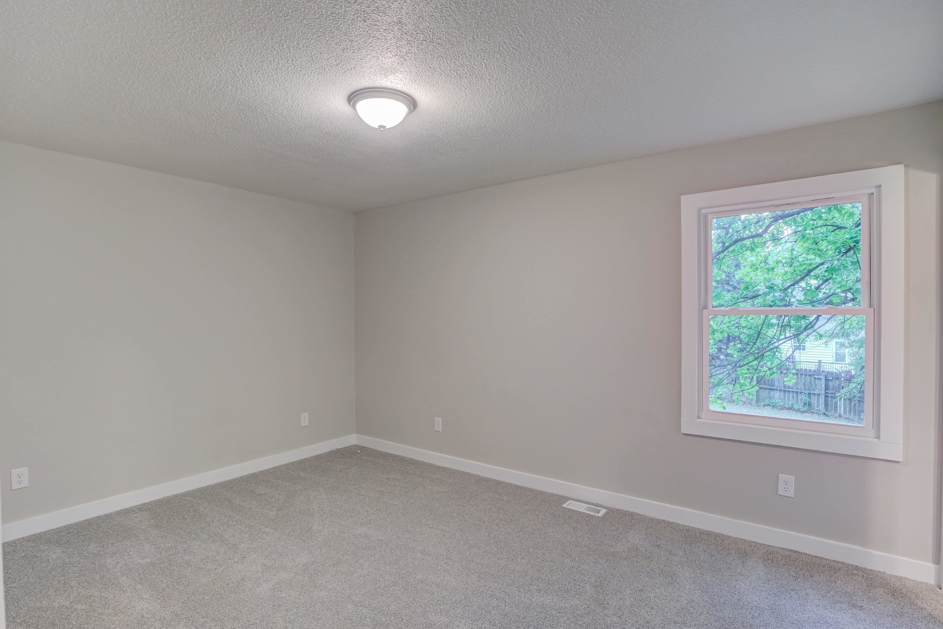 5404 Pear Orchard Lane Raleigh, NC 27616 - Photo 13 of 22 an empty room with a window