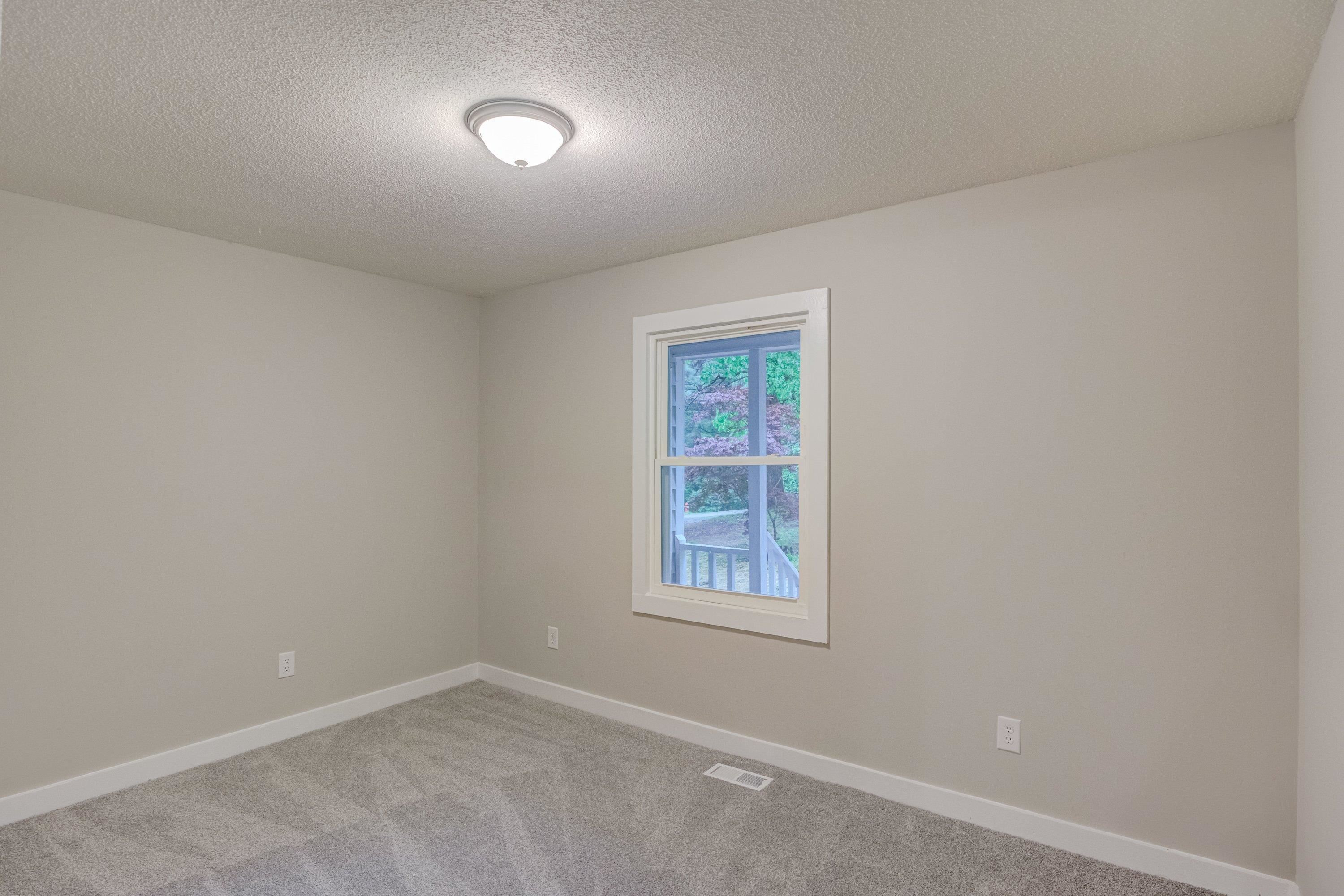 5404 Pear Orchard Lane Raleigh, NC 27616 - Photo 14 of 22 an empty room with a window