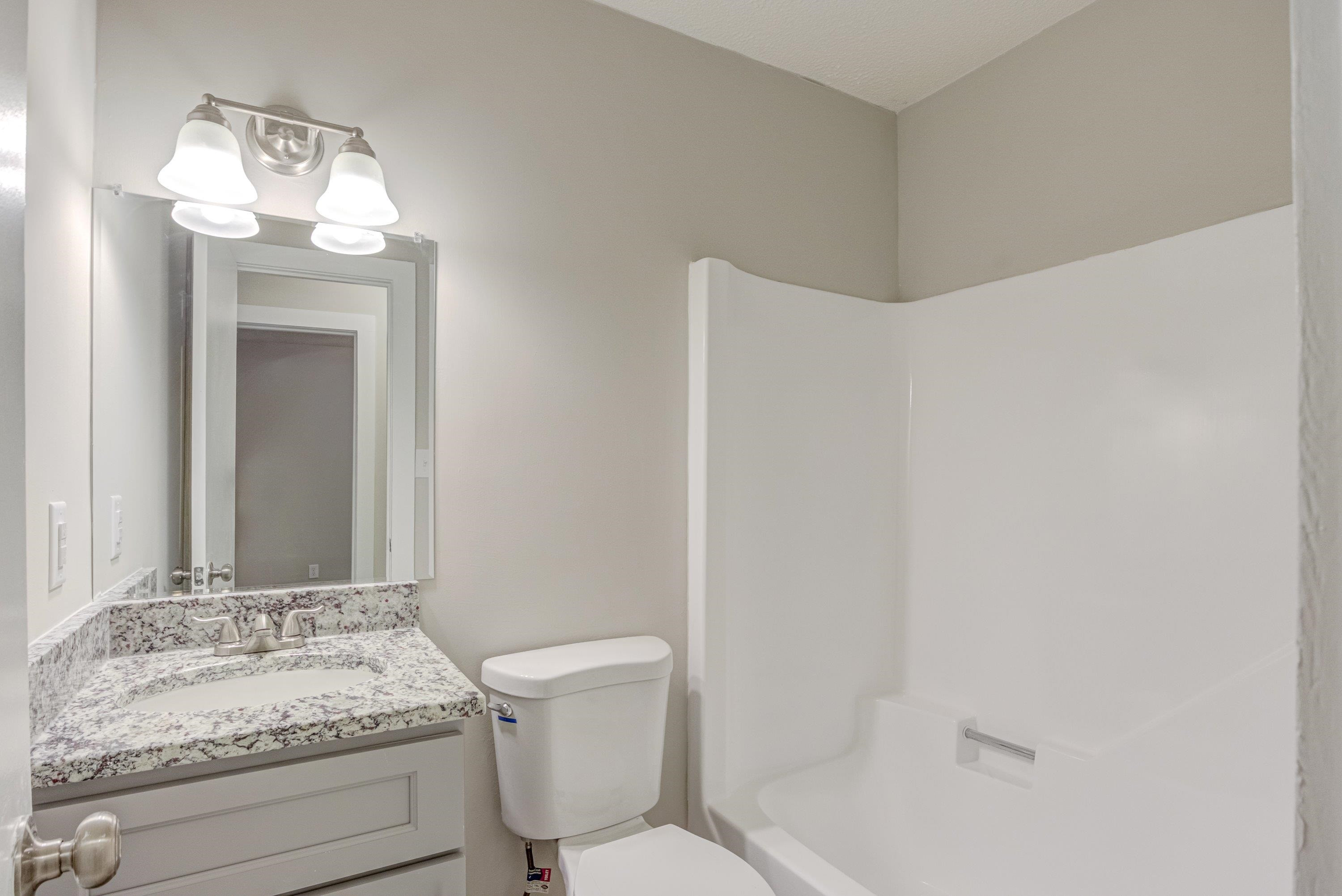 5404 Pear Orchard Lane Raleigh, NC 27616 - Photo 15 of 22 a bathroom with a sink a toilet and shower