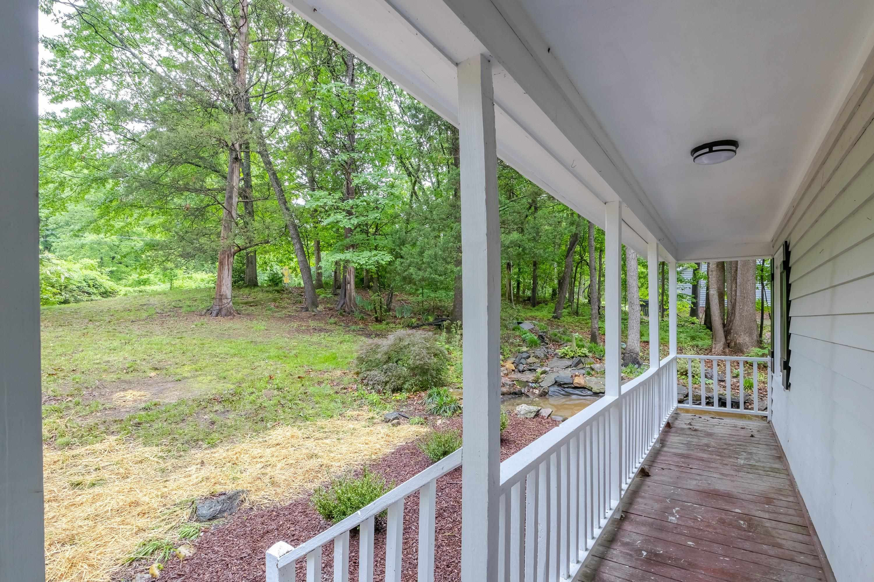 5404 Pear Orchard Lane Raleigh, NC 27616 - Photo 16 of 22 a view of a porch with wooden floor and outdoor space