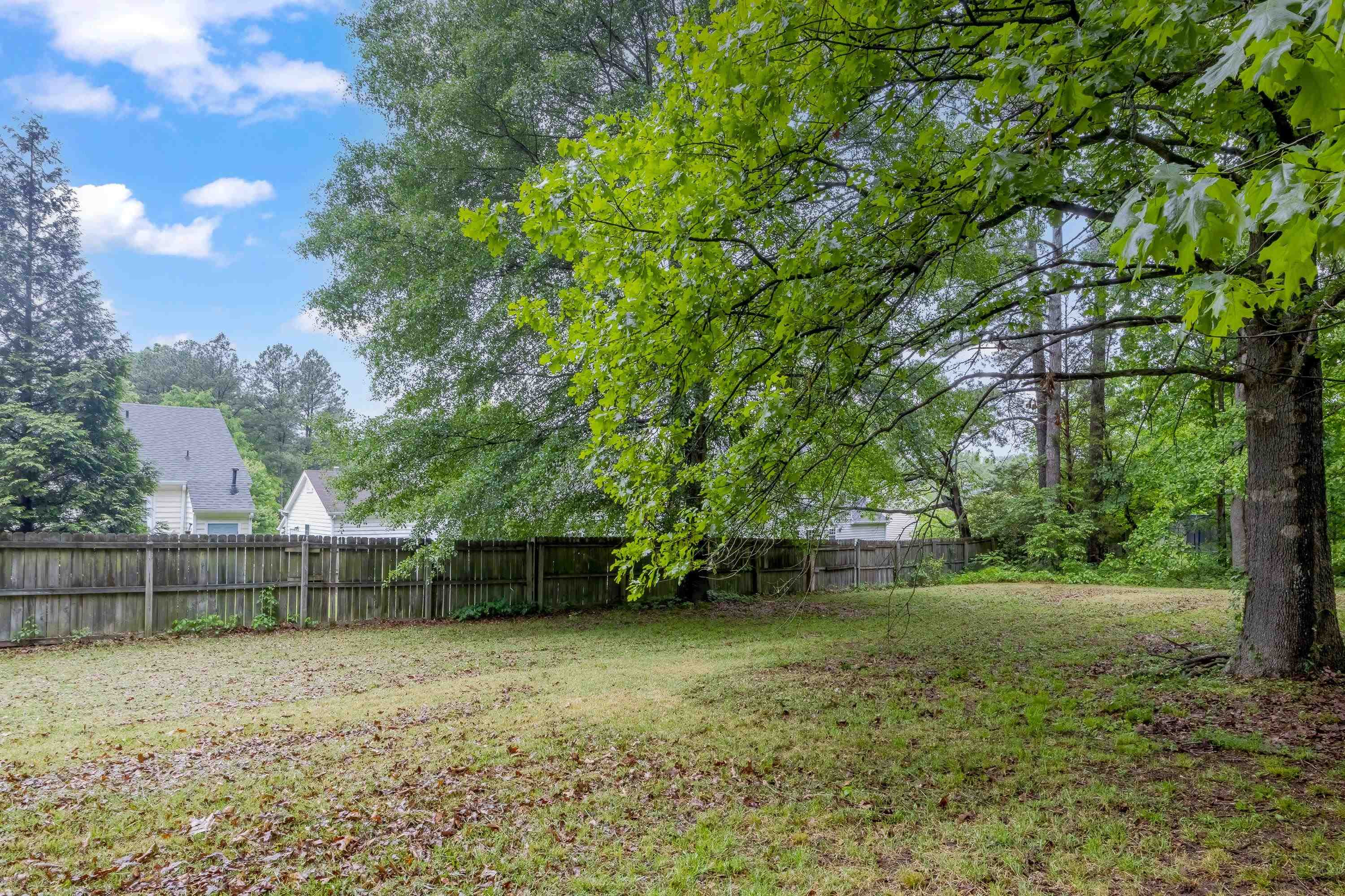 5404 Pear Orchard Lane Raleigh, NC 27616 - Photo 22 of 22 a backyard of a house with lots of green space