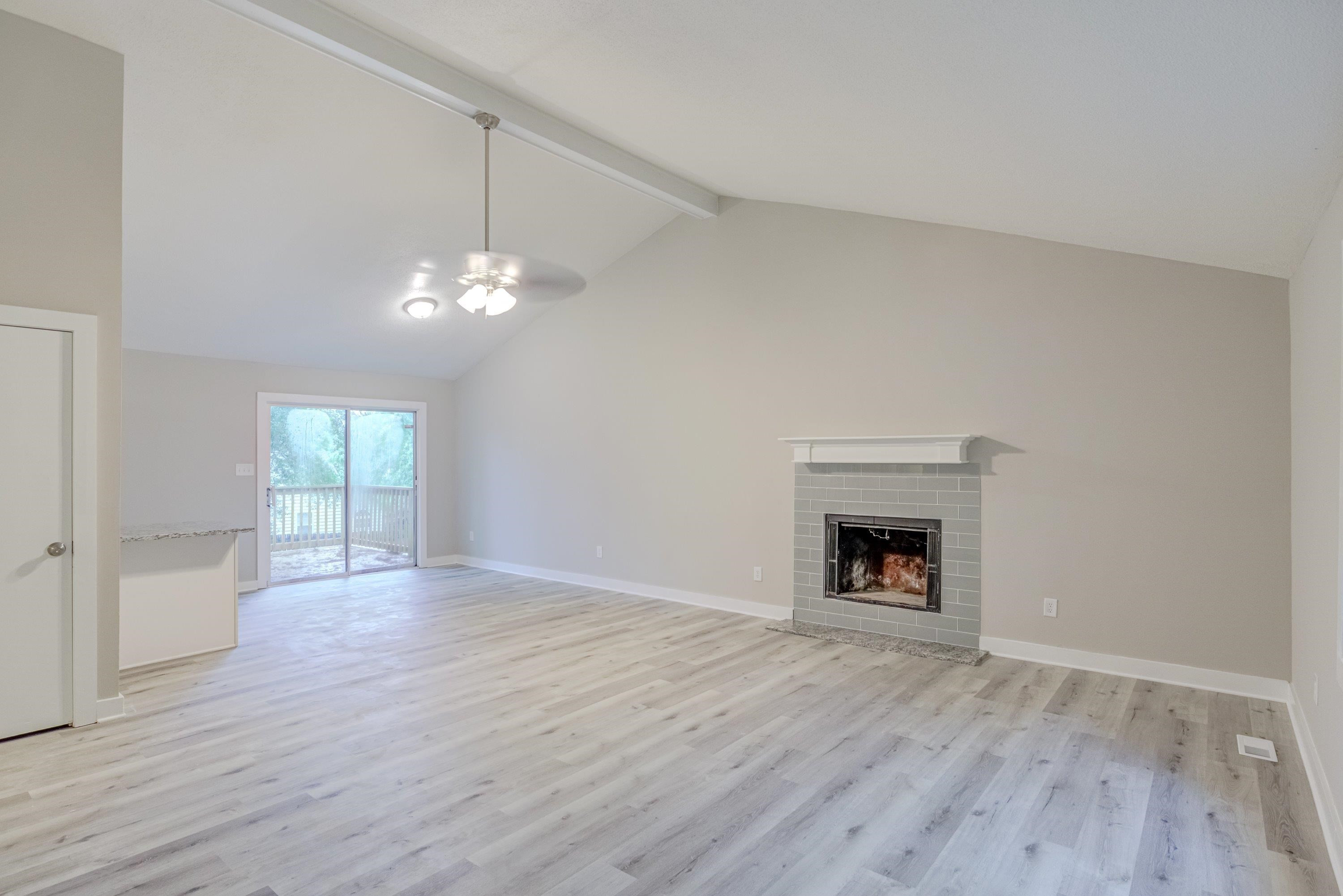 5404 Pear Orchard Lane Raleigh, NC 27616 - Photo 4 of 22 a view of an empty room with window and wooden floor