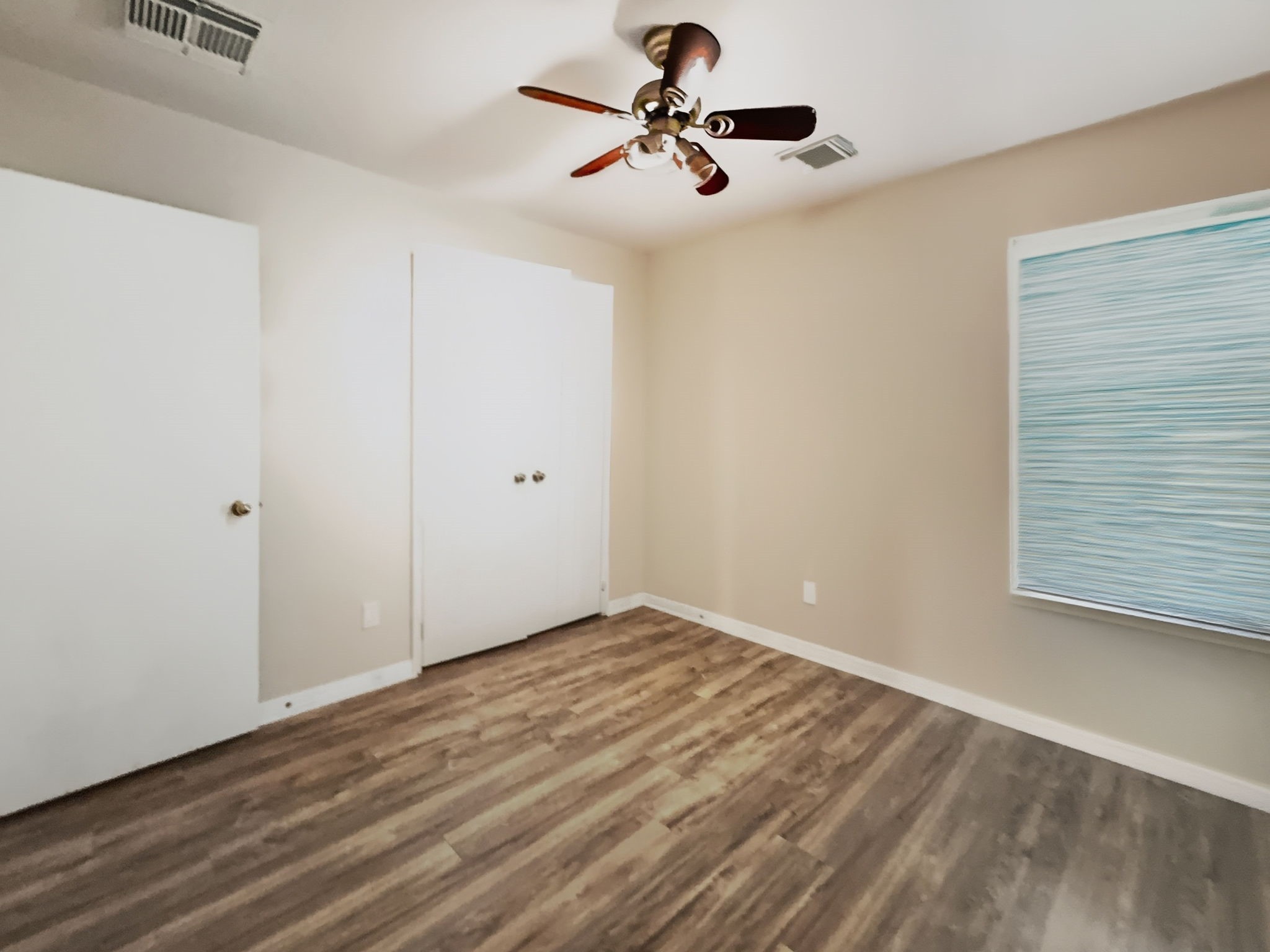 29502 Legends Pine Lane Spring, TX 77386 - Photo 13 of 15 a view of an empty room with window and wooden floor