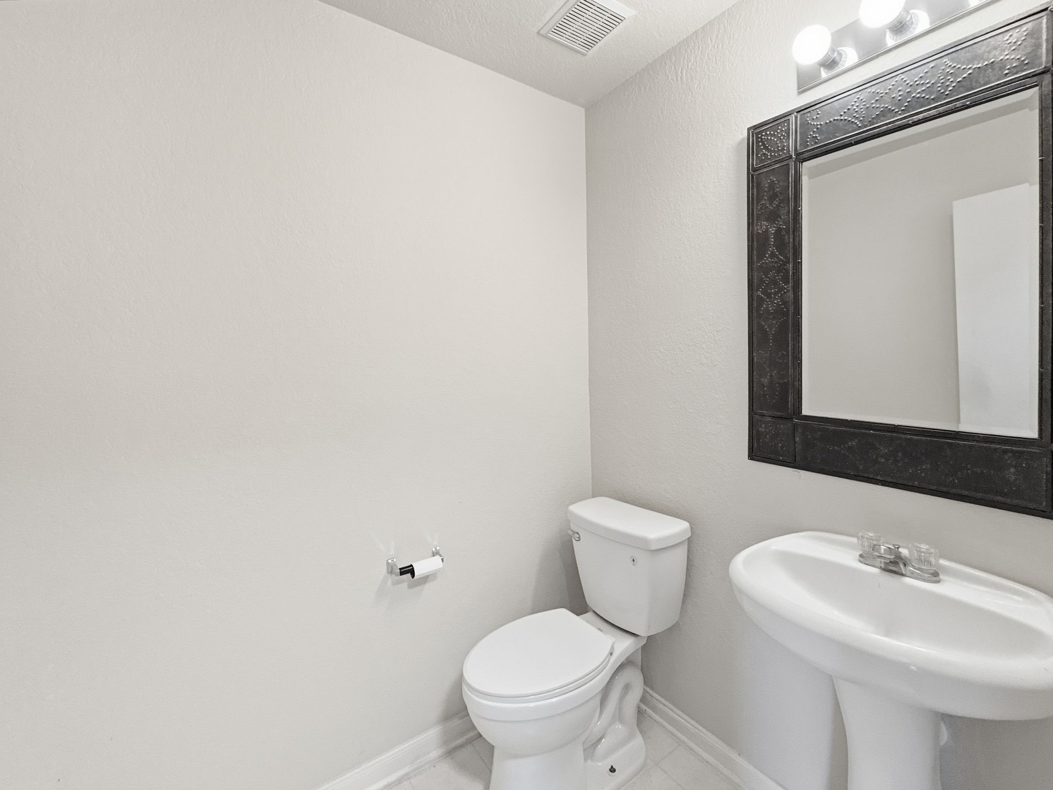 29502 Legends Pine Lane Spring, TX 77386 - Photo 6 of 15 a bathroom with a toilet a sink and mirror