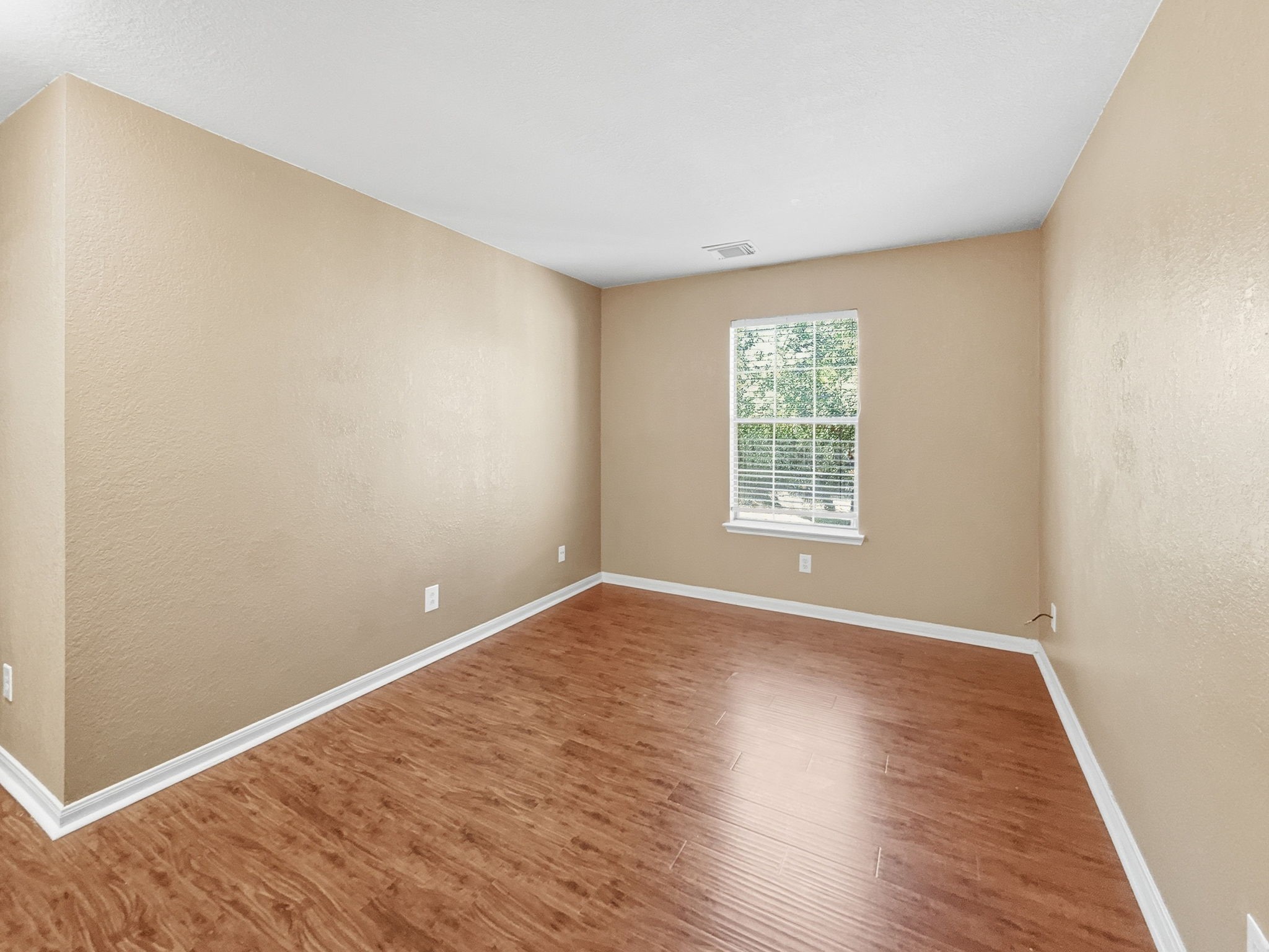 29502 Legends Pine Lane Spring, TX 77386 - Photo 7 of 15 a view of an empty room with wooden floor and a window