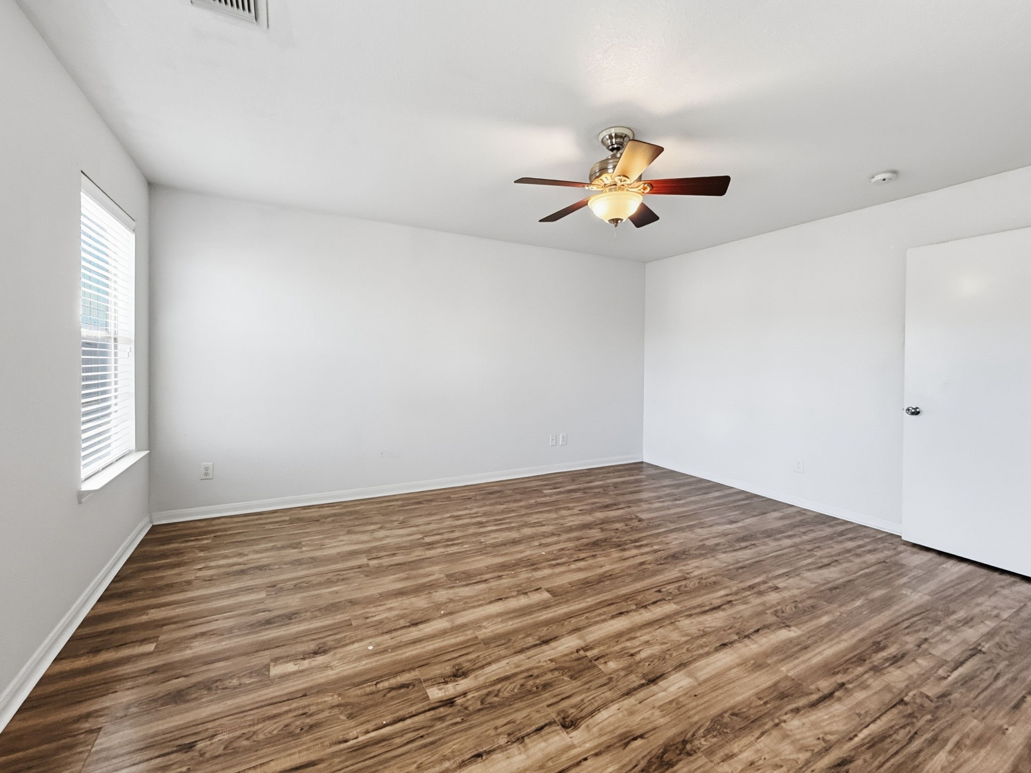 29502 Legends Pine Lane Spring, TX 77386 - Photo 9 of 15 a view of empty room with wooden floor and fan