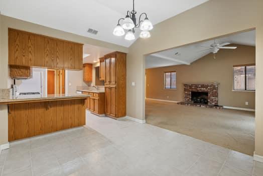 913 Valley Way Madera, CA 93637 - Photo 13 of 39 a large kitchen with a refrigerator and a sink