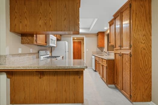 913 Valley Way Madera, CA 93637 - Photo 15 of 39 a kitchen with stainless steel appliances granite countertop wooden cabinets and a counter top space