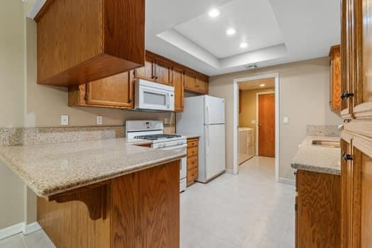 913 Valley Way Madera, CA 93637 - Photo 16 of 39 a kitchen with a sink a refrigerator and cabinets