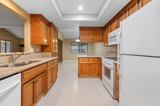 913 Valley Way Madera, CA 93637 - Photo 17 of 39 a kitchen with stainless steel appliances granite countertop a stove a sink and a refrigerator