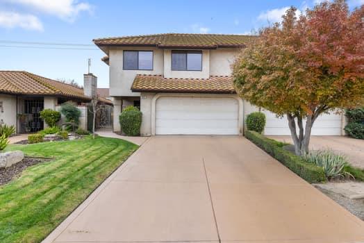 913 Valley Way Madera, CA 93637 - Photo 2 of 39 a front view of a house with a garden