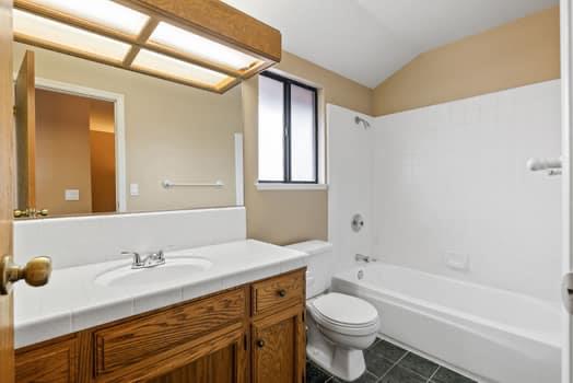 913 Valley Way Madera, CA 93637 - Photo 25 of 39 a bathroom with a granite countertop sink toilet and shower