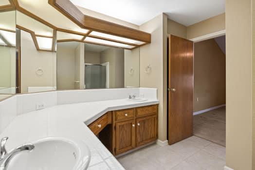 913 Valley Way Madera, CA 93637 - Photo 32 of 39 a bathroom with a sink and mirror with bathtub