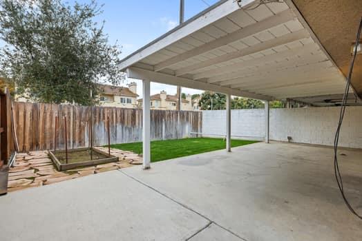 913 Valley Way Madera, CA 93637 - Photo 33 of 39 a view of a backyard with wooden fence