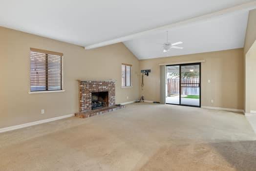 913 Valley Way Madera, CA 93637 - Photo 8 of 39 a view of a livingroom with a fireplace and window