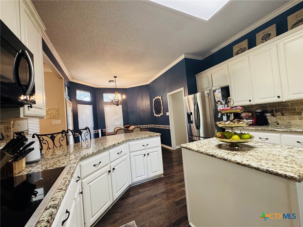 115 Oak Ridge Road Gatesville, TX 76528 - Photo 11 of 37 a kitchen with stainless steel appliances granite countertop a stove a sink dishwasher and a refrigerator
