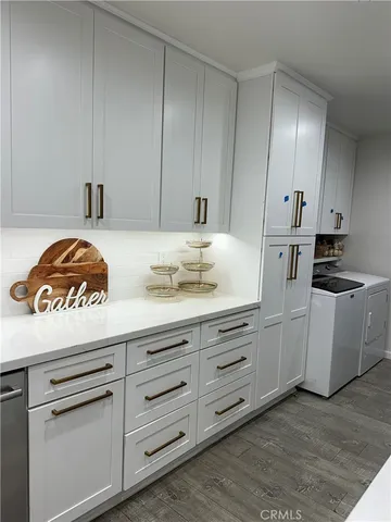 a kitchen with white cabinets and white appliances