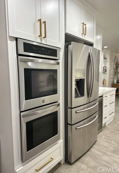 12280 Caladre Avenue Downey, CA 90242 - Photo 6 of 15 a kitchen with cabinets stainless steel appliances and wooden floor
