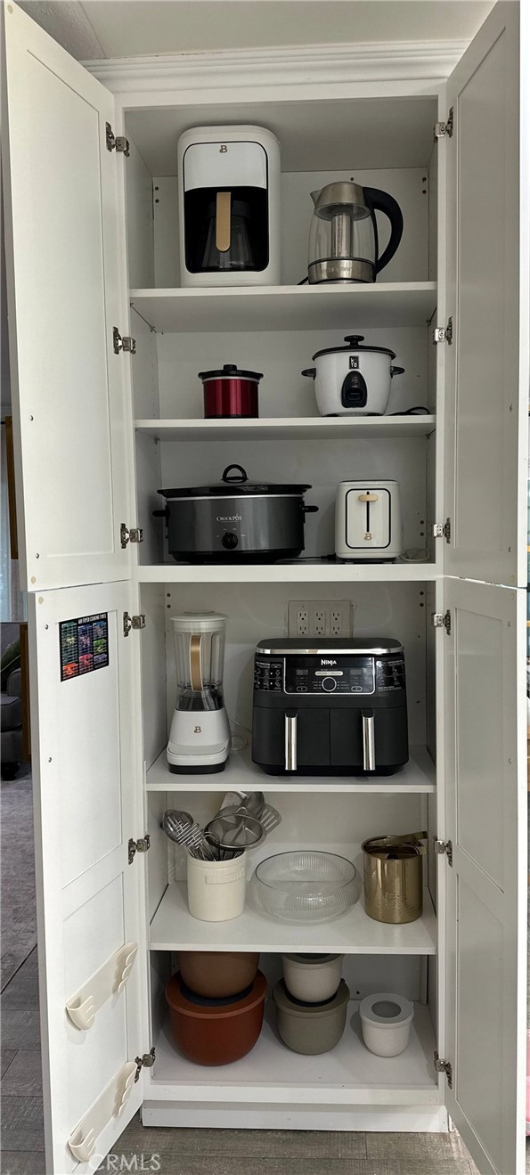 12280 Caladre Avenue Downey, CA 90242 - Photo 7 of 15 a kitchen with white cabinets and white appliances