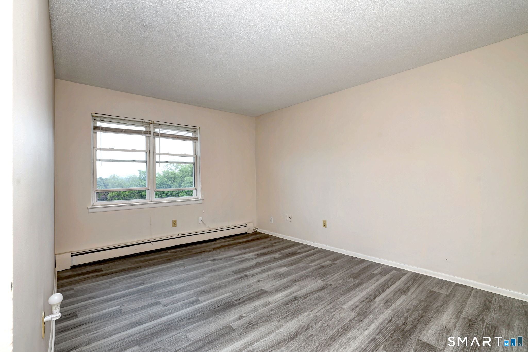 43 Balance Rock Road, Unit 11 Seymour, CT 06483 - Photo 26 of 40 an empty room with wooden floor and windows
