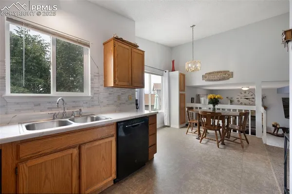 a kitchen with a table chairs sink and cabinets