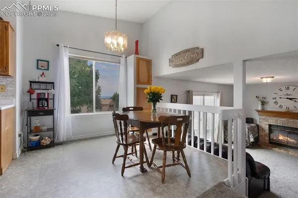 a view of a dining room with furniture and a chandelier