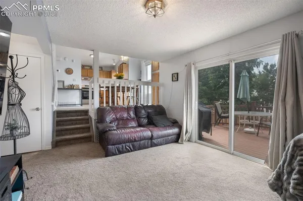 a living room with furniture and a floor to ceiling window