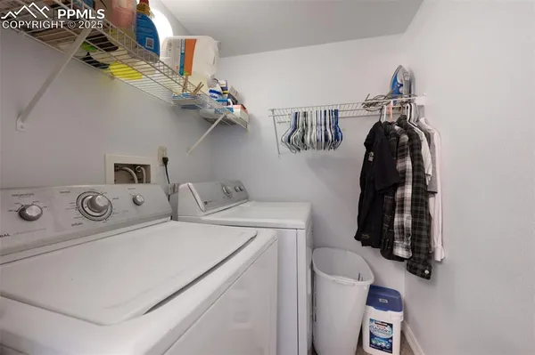 a view of storage and utility room with washer and dryer