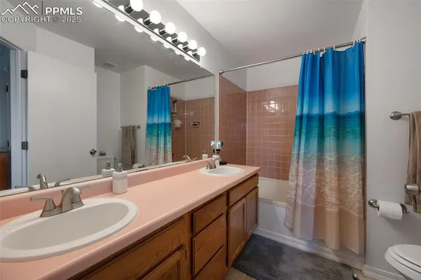 a bathroom with a sink double vanity and a mirror
