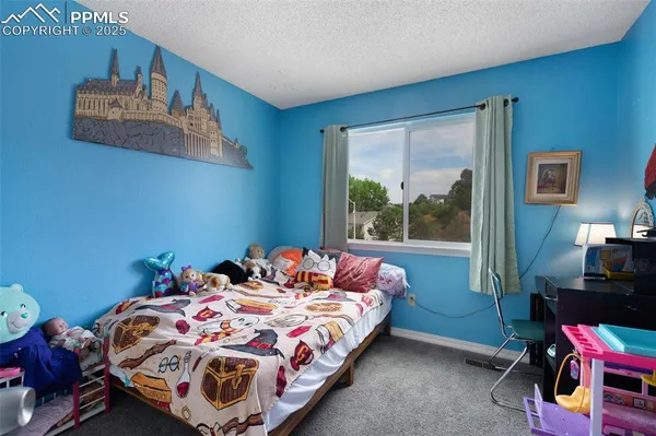 a bedroom with a bed and dresser