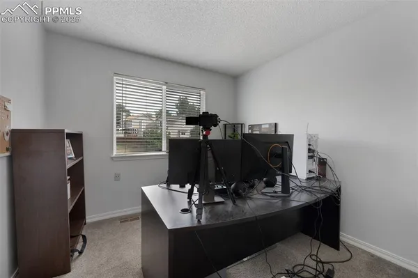 a view of a workspace with furniture