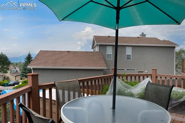 a balcony with table and chairs