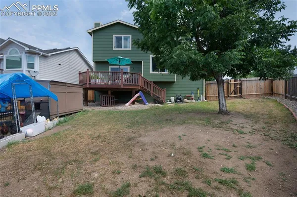 a view of a house with a yard and sitting area
