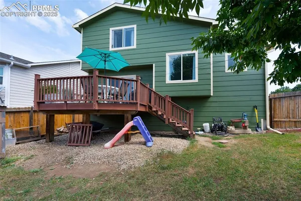 a view of a house with backyard and porch