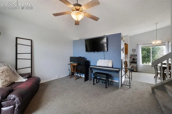 a view of a livingroom with workspace and a window