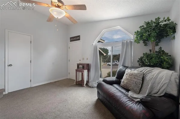 a living room with furniture and a large window