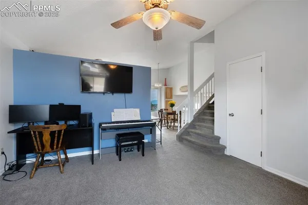 a view of a livingroom with workspace and a window