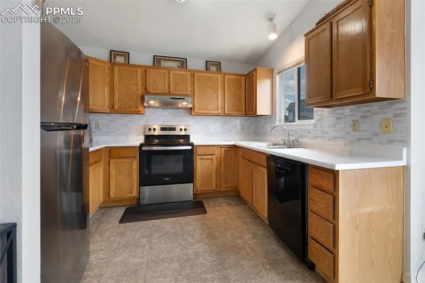 a kitchen with a sink stove and refrigerator