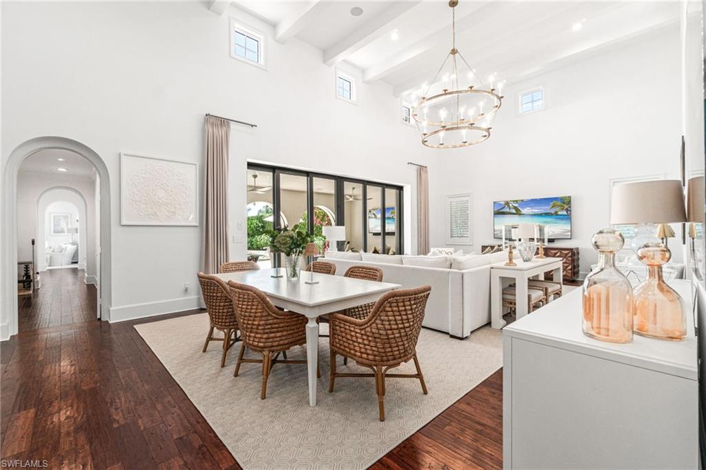 16755 Lucarno Way Naples, FL 34110 - Photo 4 of 50 a view of a dining room with furniture a chandelier and wooden floor