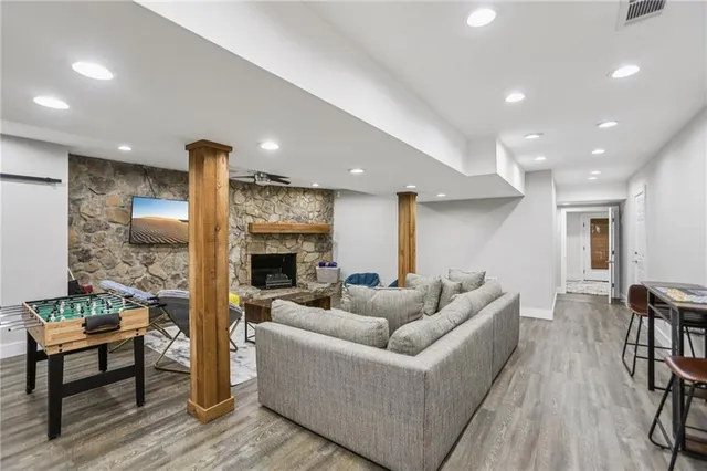 a living room with furniture wooden floor and a fireplace