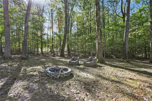 a view of a backyard with table and chairs