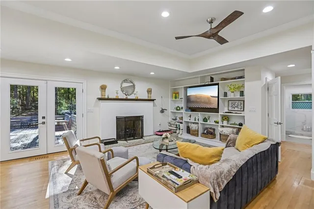 a living room with furniture a flat screen tv and a fireplace