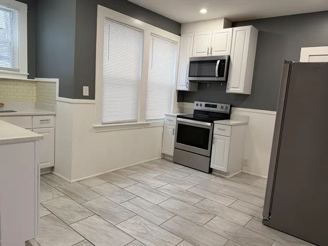 a kitchen with a refrigerator stove and microwave
