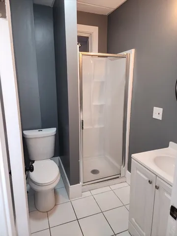 a bathroom with a toilet and a shower