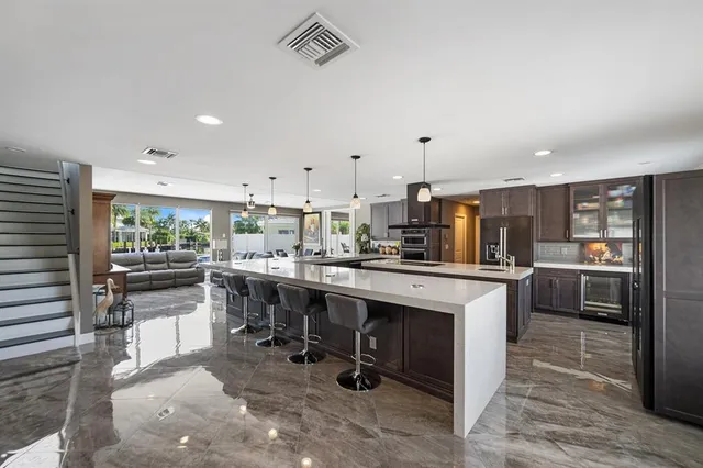a large kitchen with a table and chairs