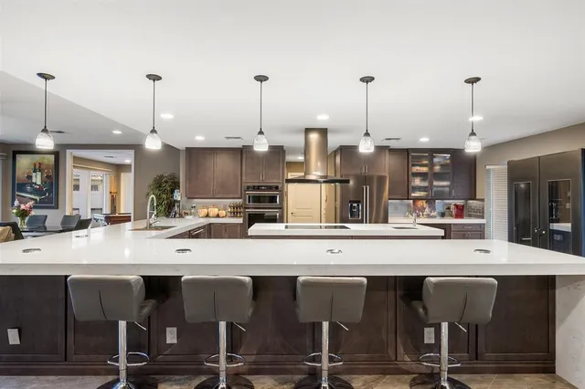 a room with furniture pool table flat screen tv and windows