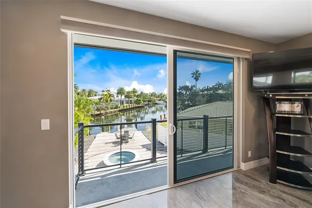 a kitchen with stainless steel appliances granite countertop a stove top oven a sink dishwasher a dining table and chairs with wooden floor