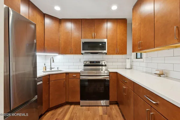a kitchen with a sink stove and microwave