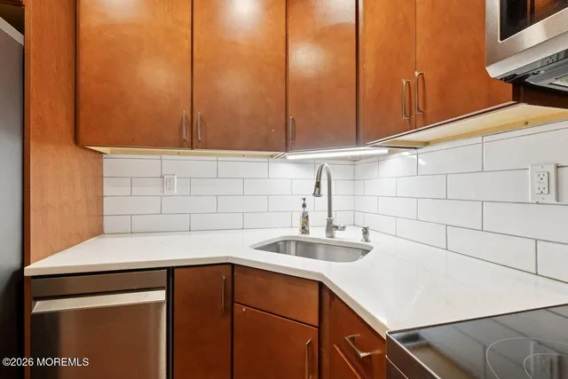 a kitchen with a sink cabinets and appliances