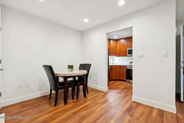a view of a dining room with furniture and wooden floor